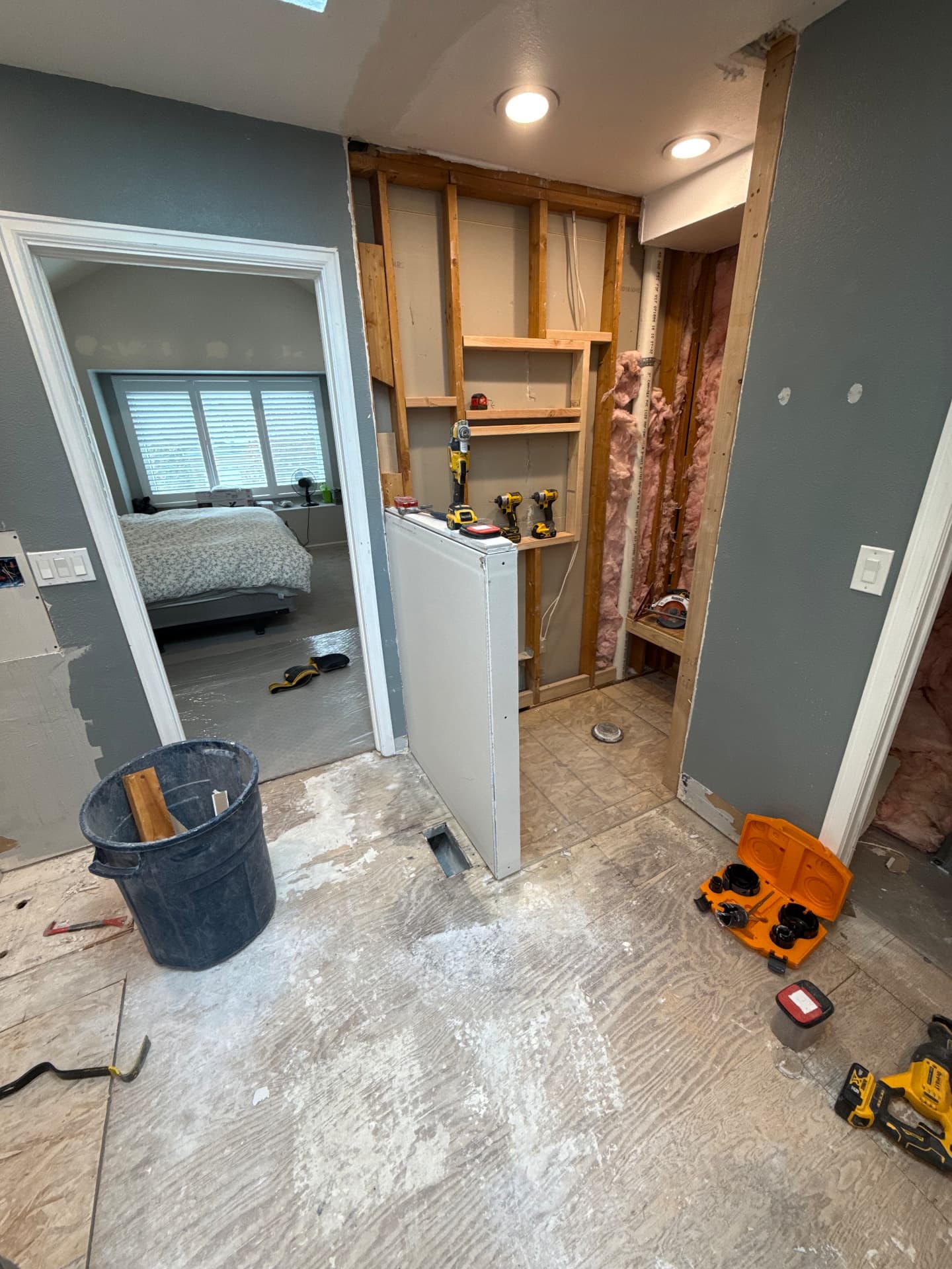 Shower area with exposed framing and insulation during renovation